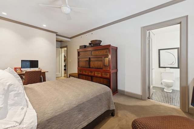 bedroom featuring connected bathroom, light colored carpet, a ceiling fan, baseboards, and ornamental molding