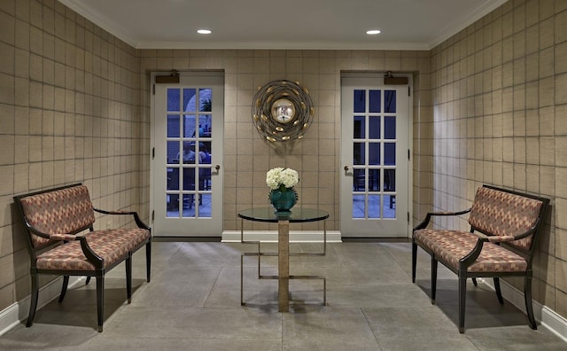 sitting room with baseboards, recessed lighting, and crown molding