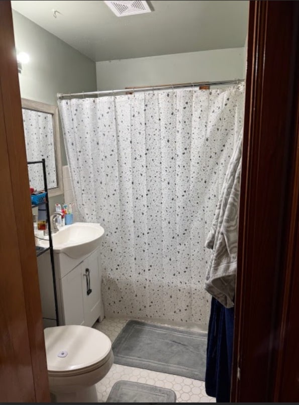 bathroom featuring vanity and toilet