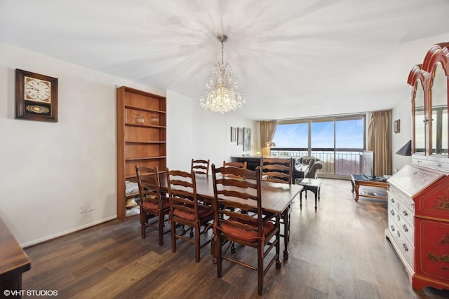 dining space featuring floor to ceiling windows, dark hardwood / wood-style flooring, and a notable chandelier