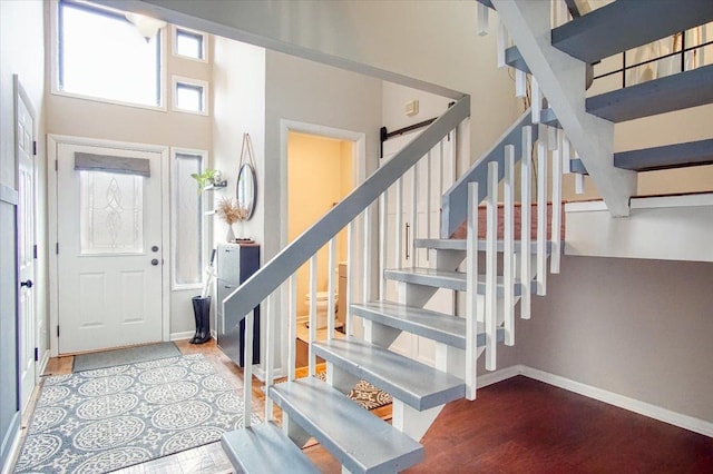 foyer entrance featuring a towering ceiling