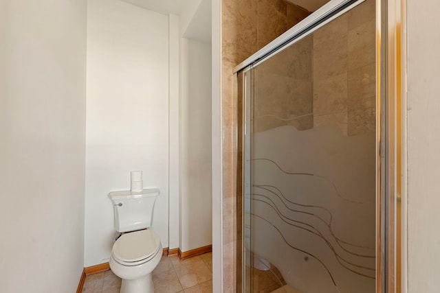 bathroom with a shower with shower door, tile patterned floors, and toilet