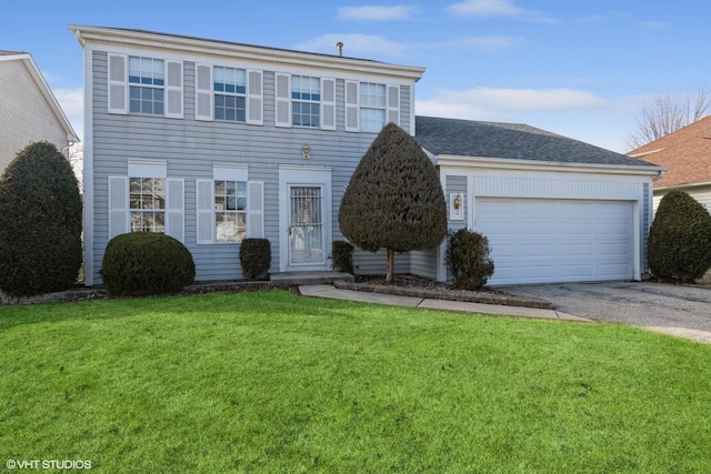 view of front of property featuring a garage and a front lawn