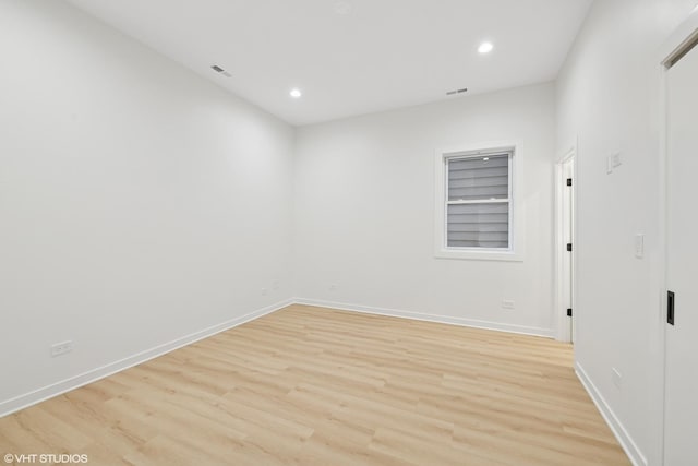 unfurnished room with light wood finished floors, baseboards, and recessed lighting