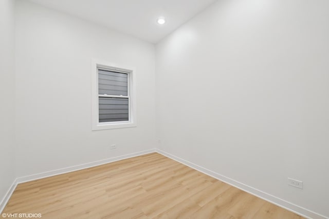 unfurnished room featuring recessed lighting, light wood-type flooring, and baseboards