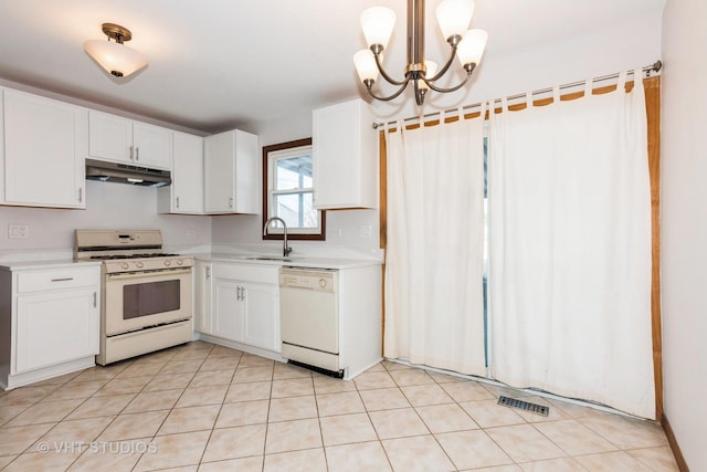 kitchen featuring sink, white appliances, white cabinets, and hanging light fixtures