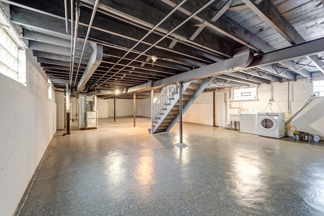 basement featuring separate washer and dryer and sink