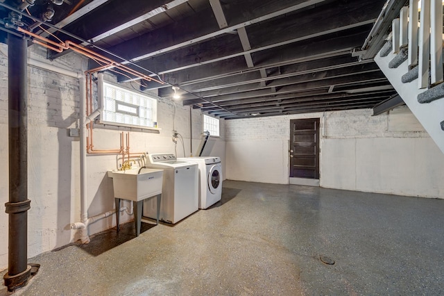 basement with washer and dryer and sink