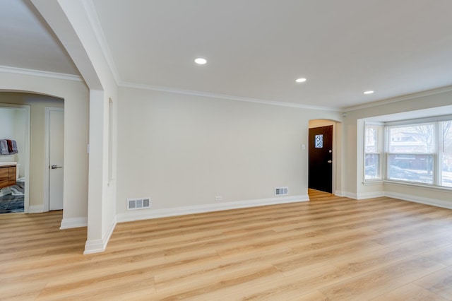 unfurnished living room with crown molding and light hardwood / wood-style floors