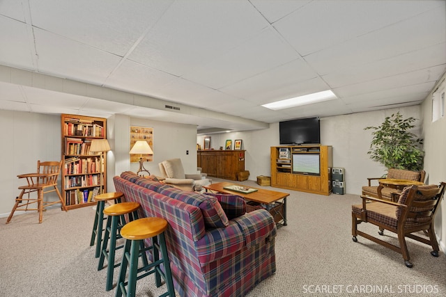 living room with visible vents, a paneled ceiling, and carpet flooring