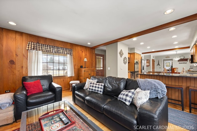 living room featuring recessed lighting, a healthy amount of sunlight, and light wood-type flooring