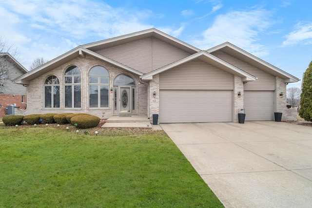 view of front of property featuring a garage, cooling unit, and a front lawn