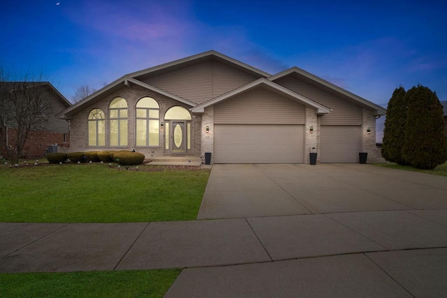 view of front of property featuring a yard and a garage