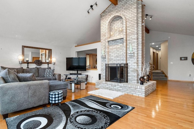8430 Horizon Ct, Tinley Park, IL 60487 - living room with wood-type flooring, a fireplace, high vaulted ceiling, and rail lighting