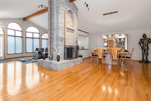 8430 Horizon Ct, Tinley Park, IL 60487 - living room with beamed ceiling, a brick fireplace, high vaulted ceiling, and light wood-type flooring