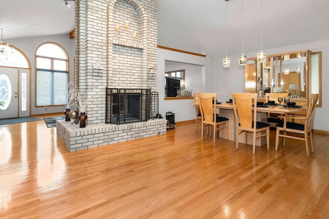 8430 Horizon Ct, Tinley Park, IL 60487 - dining room with high vaulted ceiling, a fireplace, and light hardwood / wood-style floors
