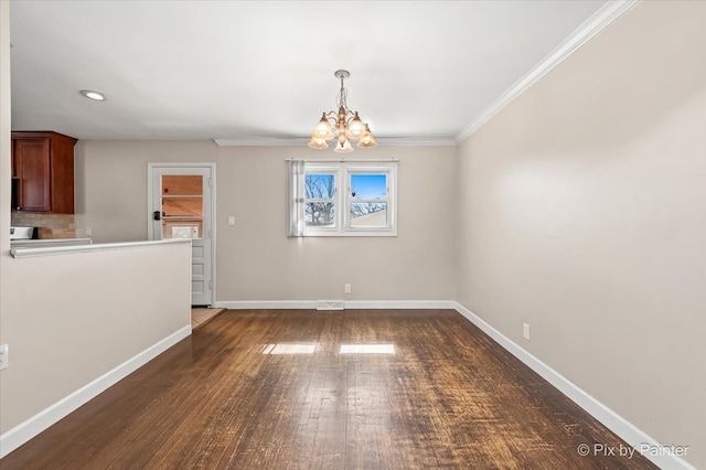 unfurnished dining area featuring a notable chandelier, wood finished floors, visible vents, baseboards, and ornamental molding