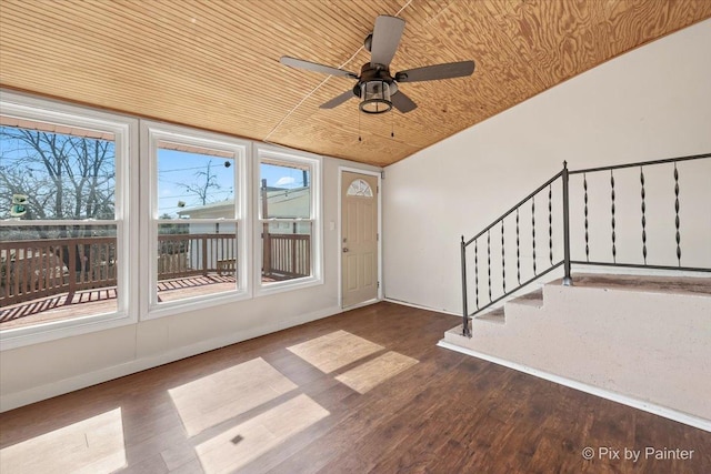 interior space featuring ceiling fan, wood finished floors, wood ceiling, baseboards, and stairway