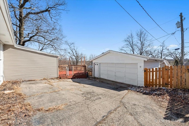 detached garage featuring fence