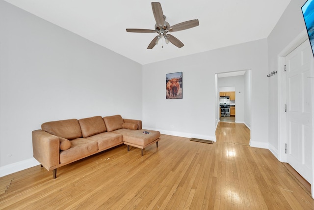 living room featuring ceiling fan and light hardwood / wood-style floors