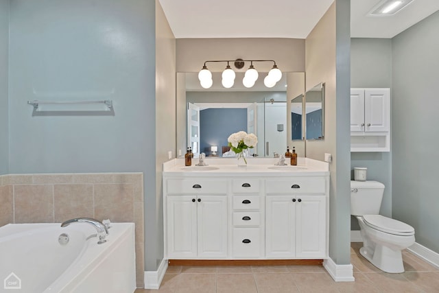 bathroom featuring tile patterned flooring, a bath, vanity, and toilet