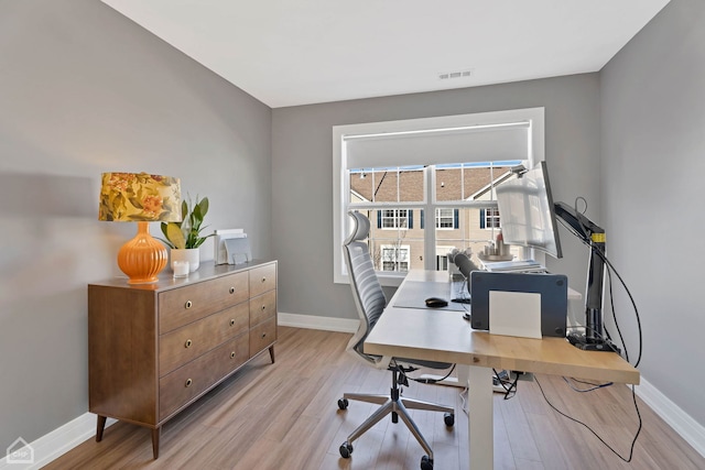 office space with light hardwood / wood-style flooring