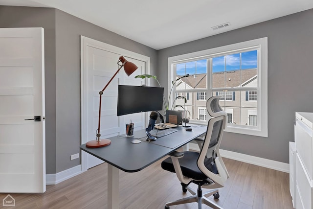 office with light wood-type flooring