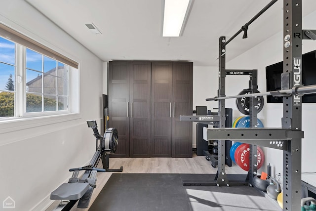 exercise room with hardwood / wood-style floors