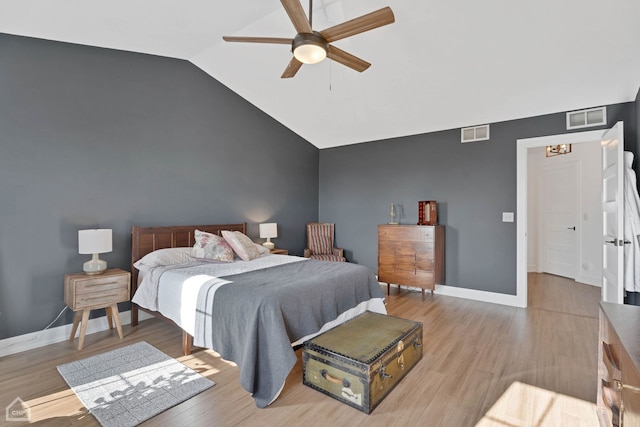 bedroom with ceiling fan, lofted ceiling, and light wood-type flooring