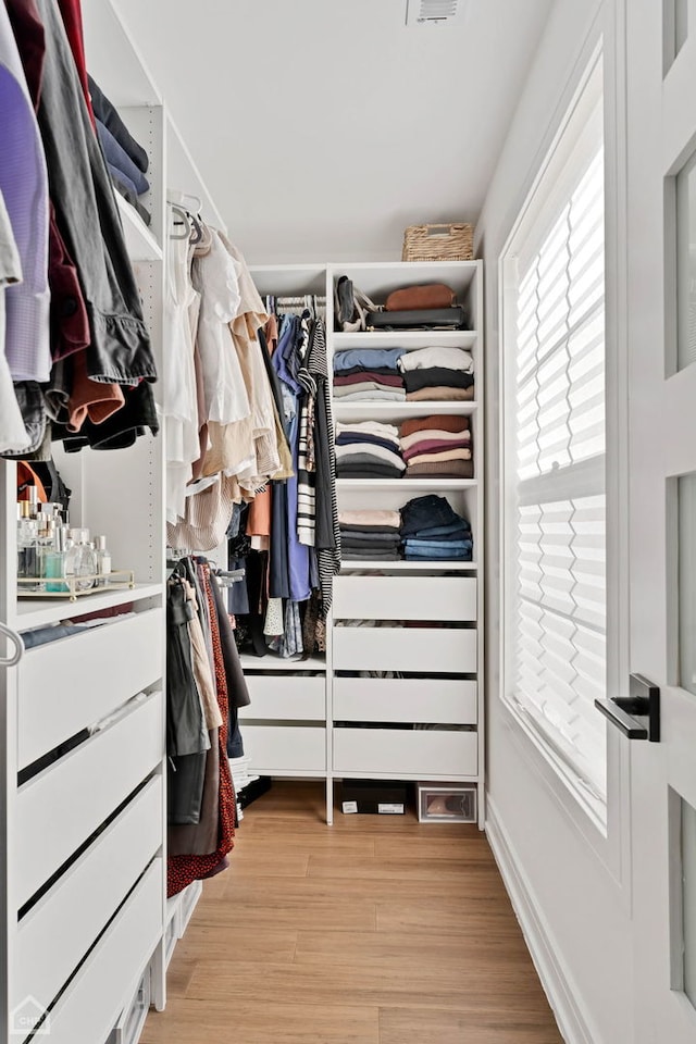 spacious closet with light hardwood / wood-style floors