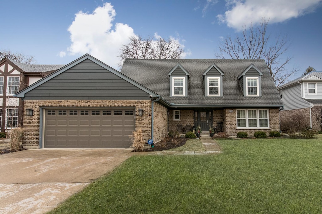 view of front of property featuring a garage and a front yard