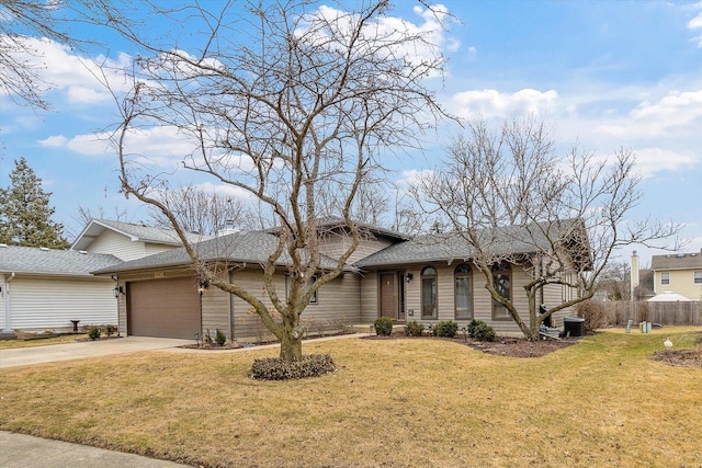 view of front of house featuring a chimney, central air condition unit, a garage, driveway, and a front lawn