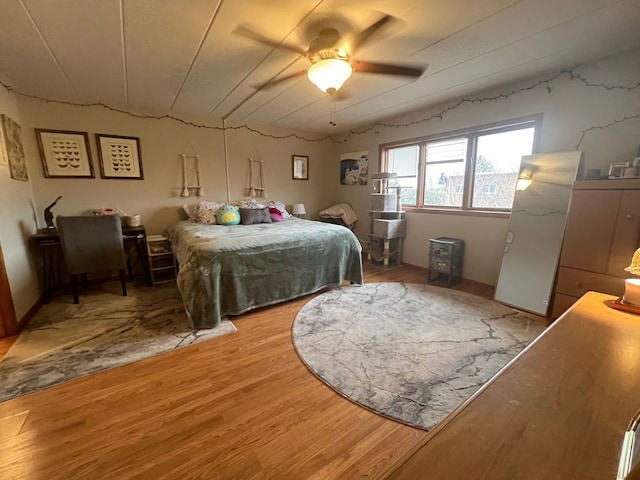 bedroom featuring hardwood / wood-style flooring and ceiling fan