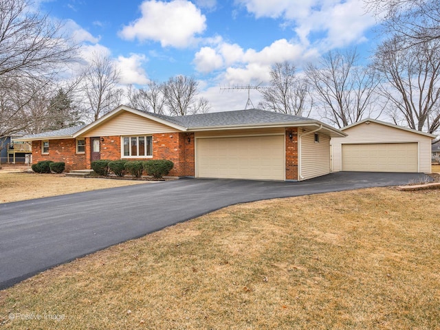 single story home featuring a garage and a front lawn