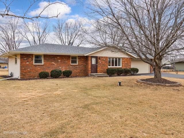 ranch-style home with a garage and a front lawn