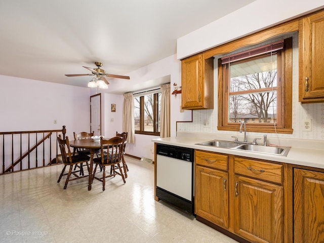 kitchen with white dishwasher, sink, and ceiling fan