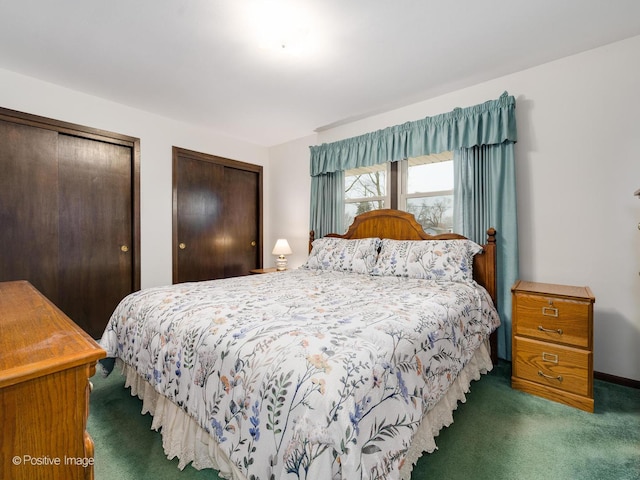 carpeted bedroom featuring two closets