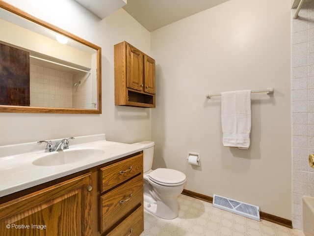 bathroom with vanity, a shower, and toilet