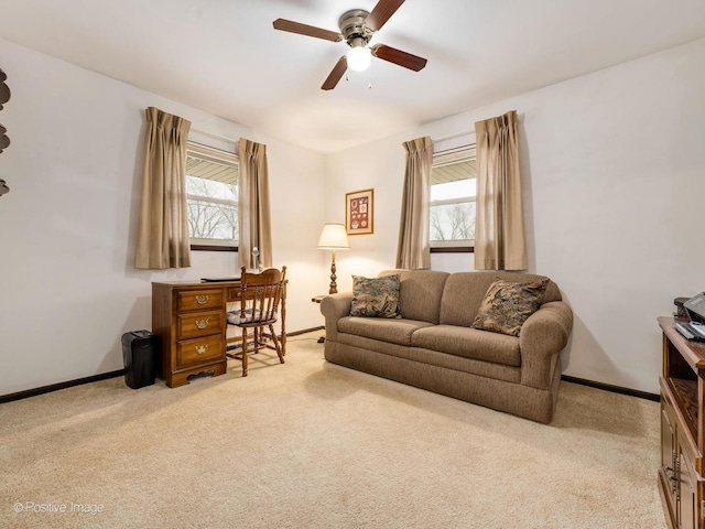 carpeted living room with ceiling fan and a healthy amount of sunlight