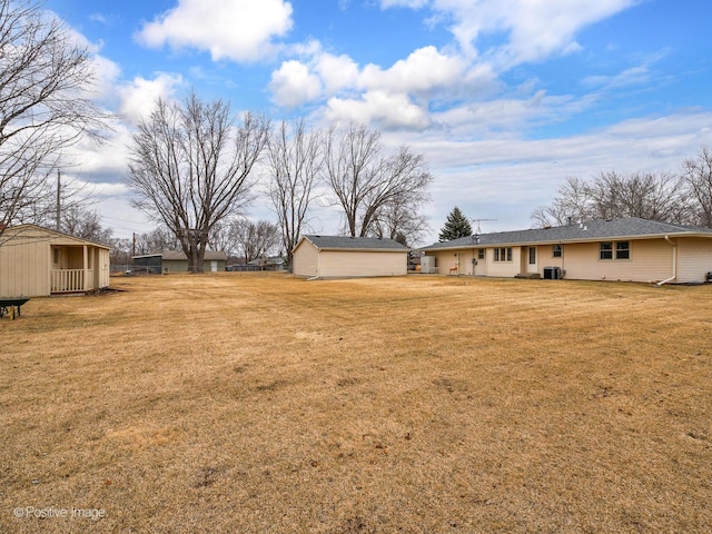 view of yard with a storage shed and central AC