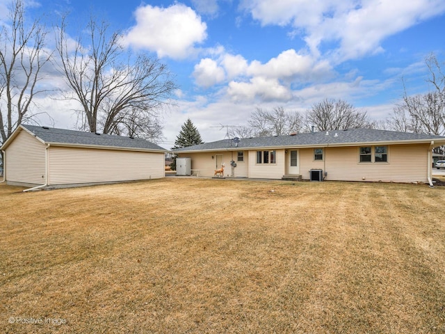 rear view of house featuring a yard and cooling unit