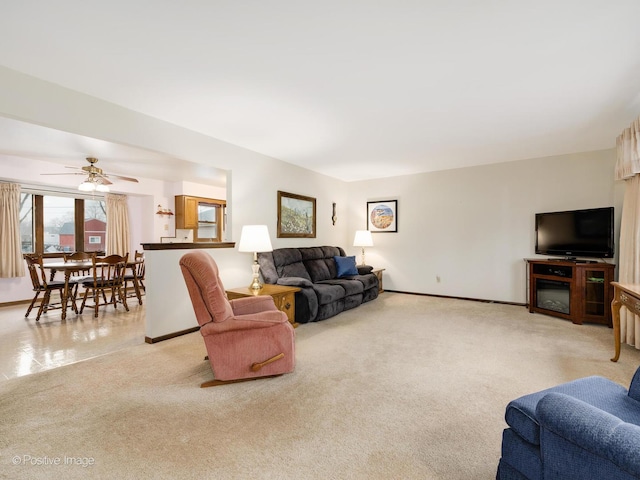 living room featuring light carpet and ceiling fan