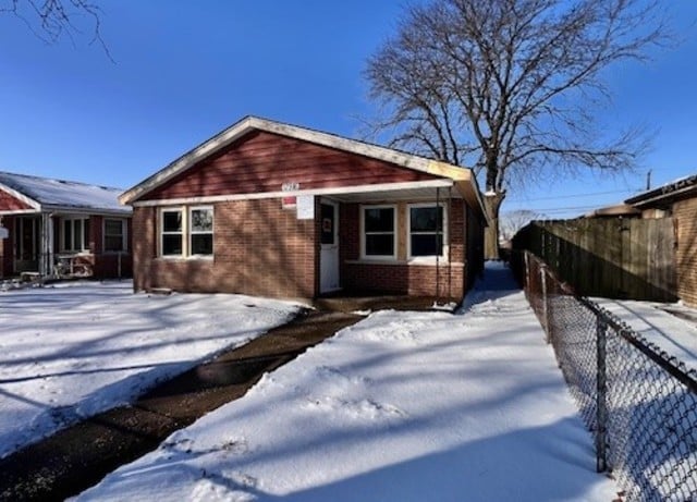 view of snow covered rear of property