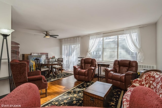 living room featuring hardwood / wood-style flooring and ceiling fan