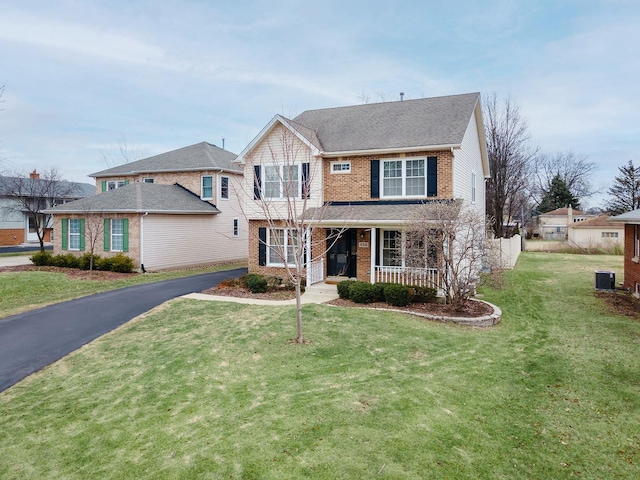 view of front of property featuring a front yard, covered porch, and central air condition unit