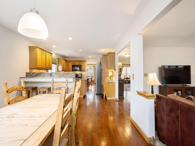 dining space with dark hardwood / wood-style floors