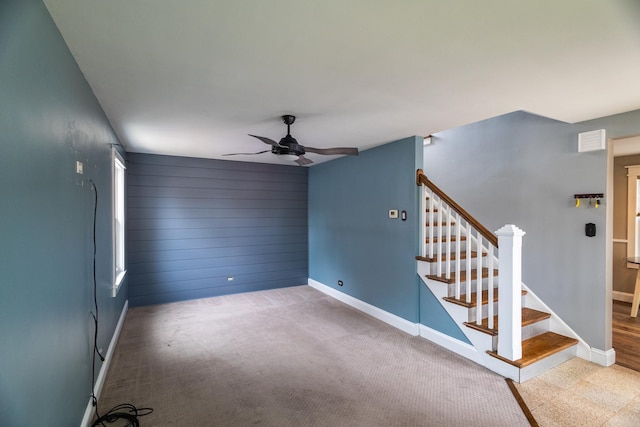 unfurnished room featuring ceiling fan and carpet