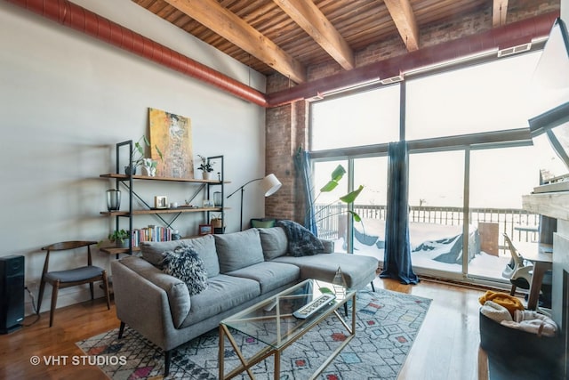 living room with beamed ceiling, wood ceiling, and hardwood / wood-style floors