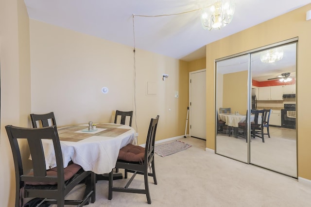 dining room featuring ceiling fan with notable chandelier and light carpet