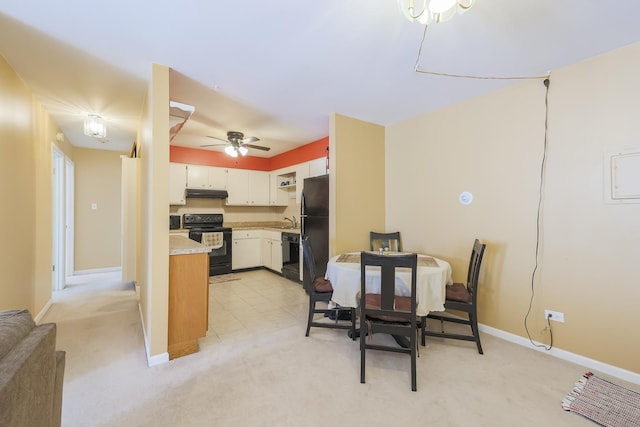 carpeted dining area featuring sink and ceiling fan